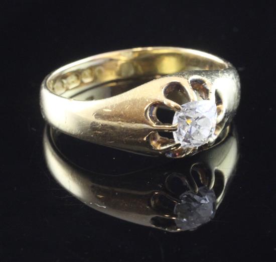 An early 20th century 18ct gold and claw set solitaire diamond ring, size S.